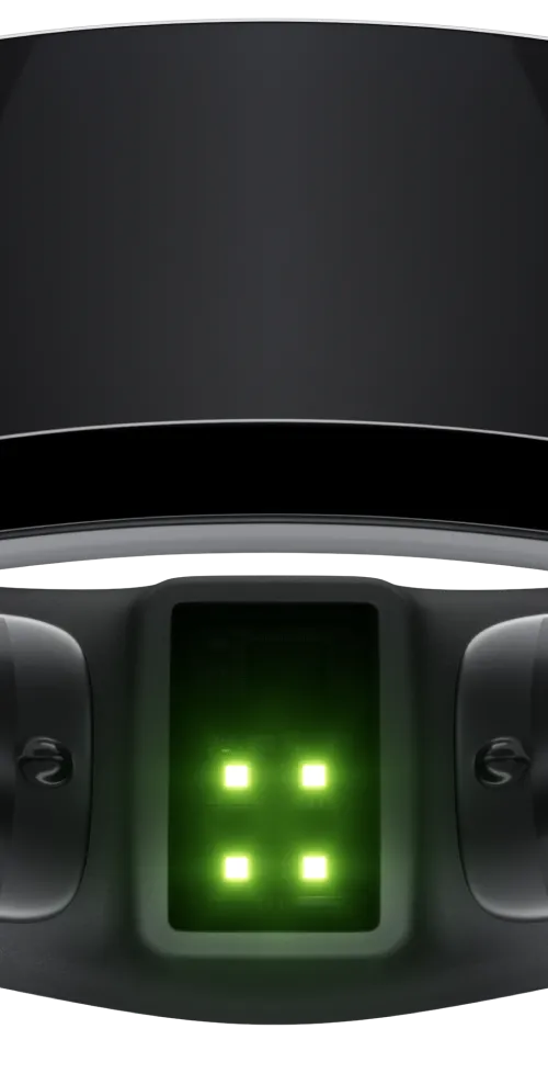 A close-up view of a sleek black ring featuring embedded technology components. Green LED lights are visible on the inner surface, suggesting functionality related to health or fitness tracking. The exterior has a shiny, polished finish.